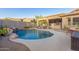 Inviting backyard swimming pool area with rock waterfall feature and desert landscaping at 26330 N 56Th Dr, Phoenix, AZ 85083