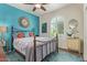 Charming bedroom with a colorful accent wall, natural light, and decorative mirrors enhancing the space at 27088 W Sequoia Dr, Buckeye, AZ 85396