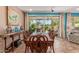 An elegant dining room with a wood table, stylish decor, and a sliding glass door leading to the backyard patio at 27088 W Sequoia Dr, Buckeye, AZ 85396