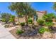 Home with desert landscaping, including mature trees and a manicured lawn at 27088 W Sequoia Dr, Buckeye, AZ 85396