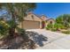 Home featuring a stucco exterior, clay tile roof, desert landscaping, with an attached two car garage at 27088 W Sequoia Dr, Buckeye, AZ 85396