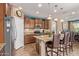 Modern kitchen with stainless steel appliances, granite countertops, and an island with seating for casual dining at 27088 W Sequoia Dr, Buckeye, AZ 85396