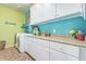 Bright laundry room with modern appliances, ample counter space, and storage cabinets for organization at 27088 W Sequoia Dr, Buckeye, AZ 85396