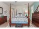 Comfortable primary bedroom with a four-poster bed, soft lighting, and neutral colors for a relaxing atmosphere at 27088 W Sequoia Dr, Buckeye, AZ 85396