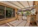 Covered patio with a pergola, stone flooring, and privacy wall creating a great outdoor space at 27088 W Sequoia Dr, Buckeye, AZ 85396