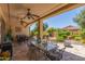 Inviting outdoor patio area perfect for entertaining, complete with a ceiling fan and well-maintained landscaping at 27088 W Sequoia Dr, Buckeye, AZ 85396