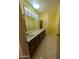 Bathroom featuring double sinks, a long countertop, and a sunlit window at 2934 W Northview Ave, Phoenix, AZ 85051