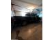 Garage featuring a black Ram 1500 pickup truck, ceiling mounted light fixture, and white door panels at 2934 W Northview Ave, Phoenix, AZ 85051