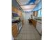 Galley kitchen features stainless steel appliances, oak cabinets and unique sky-scene ceiling panel at 2934 W Northview Ave, Phoenix, AZ 85051