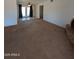 Large living room with carpet flooring, decorative brick fireplace, and French door access to backyard at 2934 W Northview Ave, Phoenix, AZ 85051