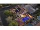 Aerial view showcasing a private backyard with a pool, spa, putting green, and solar panels at 2985 N Point Ridge Rd, Buckeye, AZ 85396