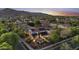 Aerial shot of a house with solar panels, a backyard pool, and lush green landscaping at 2985 N Point Ridge Rd, Buckeye, AZ 85396