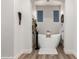 Relaxing soaking tub with modern fixtures, set in a brightly lit bathroom with luxury vinyl floors at 2985 N Point Ridge Rd, Buckeye, AZ 85396