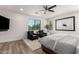 Bright bedroom features a ceiling fan, wood floors, a fluffy rug, and two lounge chairs near a window at 2985 N Point Ridge Rd, Buckeye, AZ 85396