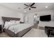 Primary bedroom features a plush grey headboard, soft white rug, and an entrance to the bathroom at 2985 N Point Ridge Rd, Buckeye, AZ 85396