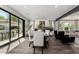 The dining room features sliding glass doors, wood-look tile flooring, neutral walls, and open concept living at 2985 N Point Ridge Rd, Buckeye, AZ 85396