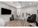 Bright exercise room with wood floors, workout equipment, and access to the outdoors at 2985 N Point Ridge Rd, Buckeye, AZ 85396