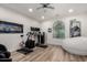 Spacious exercise room with modern equipment, light wood floors, and natural lighting at 2985 N Point Ridge Rd, Buckeye, AZ 85396