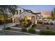 Inviting home with a front yard, archway entrance, three-car garage, and warm exterior lighting at 2985 N Point Ridge Rd, Buckeye, AZ 85396