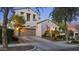 A two-story home features a front lawn, a garage, and beautiful Southwestern architectural details at 2985 N Point Ridge Rd, Buckeye, AZ 85396