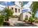 Beautiful two-story house showcasing a neutral color scheme, and a lovely green, landscaped front yard at 2985 N Point Ridge Rd, Buckeye, AZ 85396