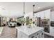 Bright kitchen features an island with white countertop, stainless steel appliances, and is open to the dining and living areas at 2985 N Point Ridge Rd, Buckeye, AZ 85396