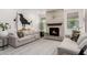 Warm living room showcases a stone fireplace, soft textures, and comfortable seating at 2985 N Point Ridge Rd, Buckeye, AZ 85396