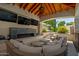 Inviting covered patio with fireplace, multiple TV's and comfortable seating area at 2985 N Point Ridge Rd, Buckeye, AZ 85396