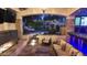 Relaxing outdoor space with a fireplace, a cushioned seating area, and lush landscaping, creating a serene oasis at 2985 N Point Ridge Rd, Buckeye, AZ 85396