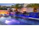 Beautiful pool showcasing fire bowls, waterfalls, palm trees, and comfortable lounge chairs for ultimate relaxation at 2985 N Point Ridge Rd, Buckeye, AZ 85396