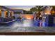 Outdoor pool featuring fire bowls, waterfalls, a swim up bar, and comfortable lounge chairs, perfect for relaxing at 2985 N Point Ridge Rd, Buckeye, AZ 85396