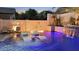 Luxurious pool showcasing fire features, waterfalls, and in-pool lounge chairs for ultimate relaxation at 2985 N Point Ridge Rd, Buckeye, AZ 85396