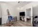 A multi-purpose room is shown with a TV, a painting easel, and views into a bedroom at 2985 N Point Ridge Rd, Buckeye, AZ 85396