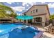 Luxurious outdoor area with a sparkling pool, swim-up bar, and ample seating for entertaining at 2985 N Point Ridge Rd, Buckeye, AZ 85396