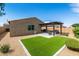 Charming backyard with artificial turf, gravel, pergola, and patio furniture, perfect for entertaining and relaxation at 3048 W Thorn Tree Dr, Phoenix, AZ 85085