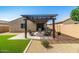 Serene backyard featuring a pergola, fire pit, patio furniture, artificial turf, and gravel landscaping at 3048 W Thorn Tree Dr, Phoenix, AZ 85085
