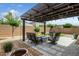 Inviting backyard patio with comfortable seating, a fire pit, and stylish pergola perfect for outdoor gatherings at 3048 W Thorn Tree Dr, Phoenix, AZ 85085