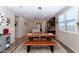 Open dining room with stylish table and bench, and views of the modern kitchen and living spaces at 3048 W Thorn Tree Dr, Phoenix, AZ 85085