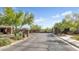 Community entrance featuring stone pillars, lush landscaping, and a secure gate for privacy at 3048 W Thorn Tree Dr, Phoenix, AZ 85085