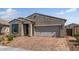 Charming home featuring a two-car garage, inviting entrance, and brick-paved driveway, enhancing curb appeal at 3048 W Thorn Tree Dr, Phoenix, AZ 85085