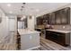Spacious kitchen with dark cabinets, center island, granite counters, and stainless steel appliances at 3048 W Thorn Tree Dr, Phoenix, AZ 85085