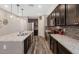 Beautiful kitchen featuring dark cabinets, stainless appliances, an island with a sink and granite countertops at 3048 W Thorn Tree Dr, Phoenix, AZ 85085
