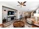 Spacious living room with brick accent wall, decorative lighting, and an open layout to the dining and kitchen at 3048 W Thorn Tree Dr, Phoenix, AZ 85085