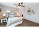 Cozy main bedroom featuring a ceiling fan, neutral walls, and a door leading to the main bathroom at 3048 W Thorn Tree Dr, Phoenix, AZ 85085