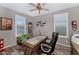 Bright home office with wood-look floors, plantation shutters, stylish decor, and comfortable seating at 3048 W Thorn Tree Dr, Phoenix, AZ 85085