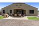 Backyard patio with outdoor dining set, grill, and ample space for entertaining guests at 30776 W Earll Dr, Buckeye, AZ 85396