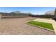 Low-maintenance backyard featuring gravel, block walls, and a synthetic grass insert at 30776 W Earll Dr, Buckeye, AZ 85396