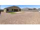 Large backyard features low-maintenance desert landscaping, a paved patio, and artificial turf accents at 30776 W Earll Dr, Buckeye, AZ 85396
