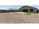 Extensive backyard with desert landscaping, artificial turf, and a covered patio area at 30776 W Earll Dr, Buckeye, AZ 85396