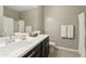 Elegant bathroom with a modern vanity, mirror, and combined shower-tub at 30776 W Earll Dr, Buckeye, AZ 85396